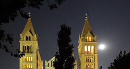 A cathedral with the Moon and Jupiter in the background