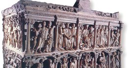 Ancient Christian stone coffin depicting biblical scenes