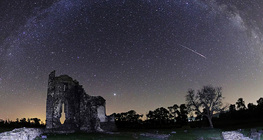 Perseid meteor streaking across the sky with Jupiter in the background