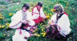 Girls playing with common dandelion