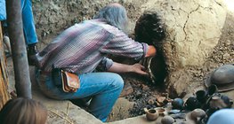 Pottery, made with prehistoric techniques, is taken out of the oven