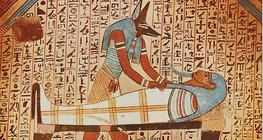 Anubis, the jackal-headed god attends the mummy