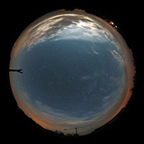 View of the setting moon through a fish-eye lens