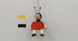 Amplitude dependence of the period of the motion of a toy suspeded on a spring